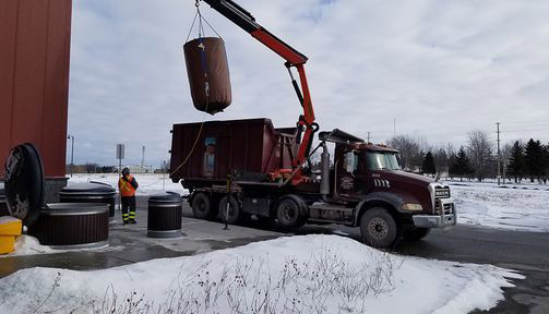 bin being transported by truck